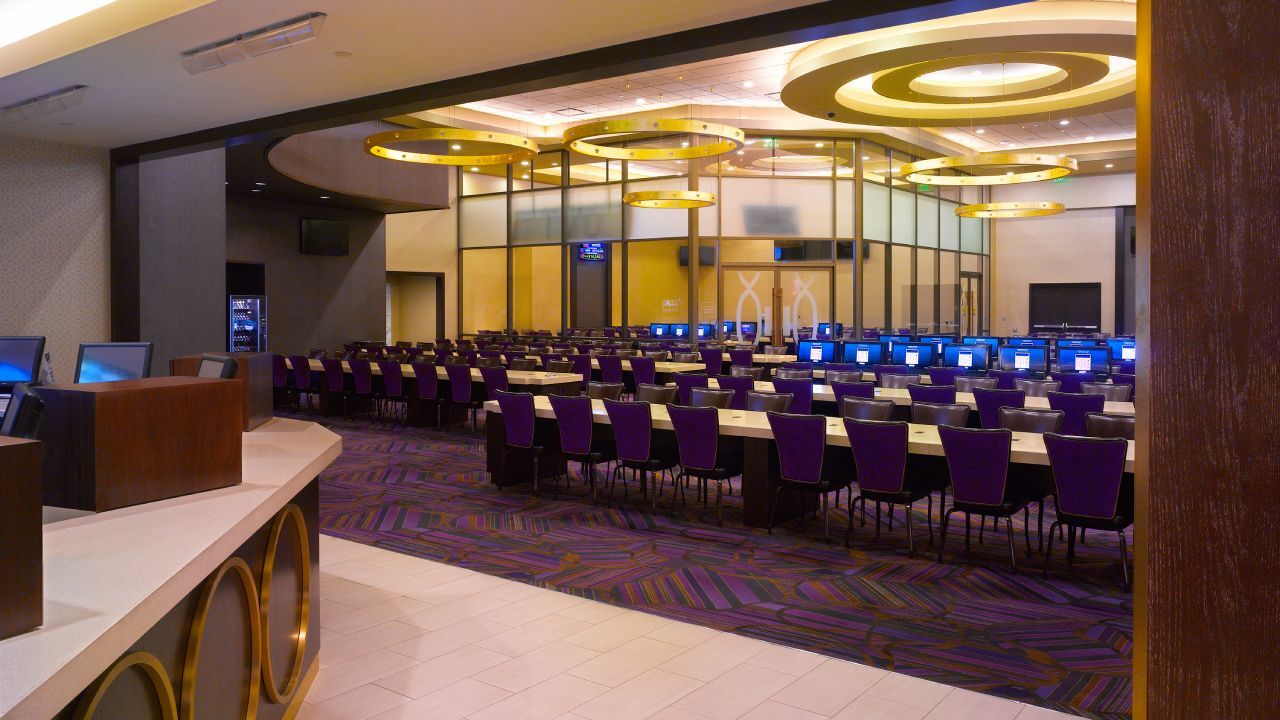 Empty bingo hall featuring chairs and bino screens