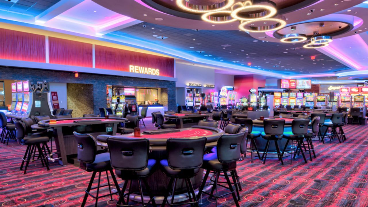 Casino floor featuring empty table games and chairs